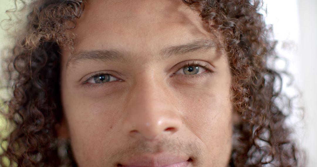 Close-Up of Person with Curly Hair Smiling Calmly - Free Images, Stock Photos and Pictures on Pikwizard.com