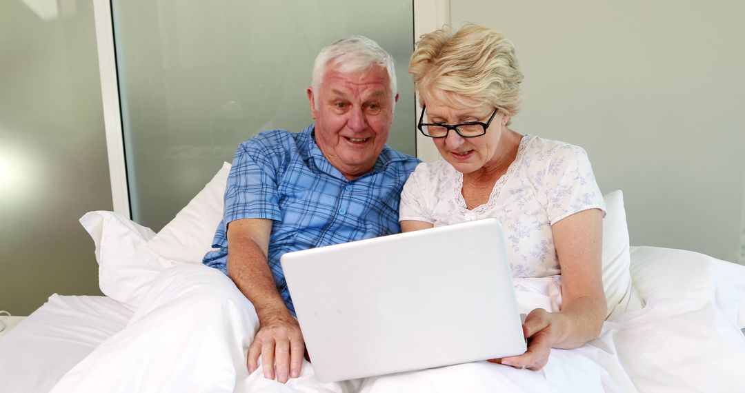 Senior Couple Using Laptop in Bed - Free Images, Stock Photos and Pictures on Pikwizard.com