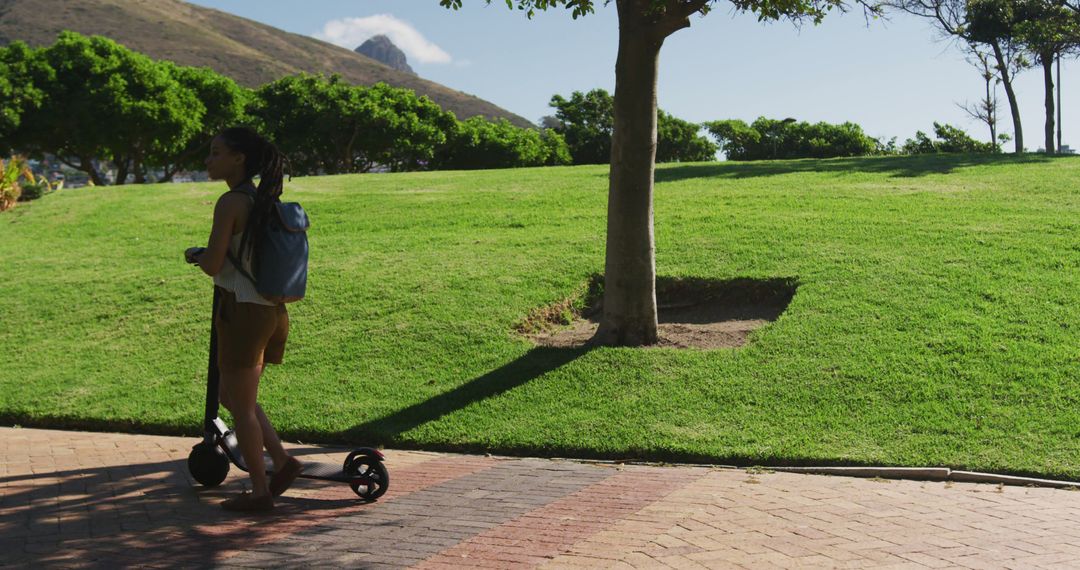 Woman Riding Electric Scooter in Park - Free Images, Stock Photos and Pictures on Pikwizard.com