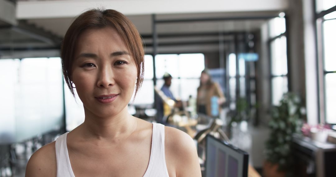 Confident Asian Businesswoman with Team in Modern Office