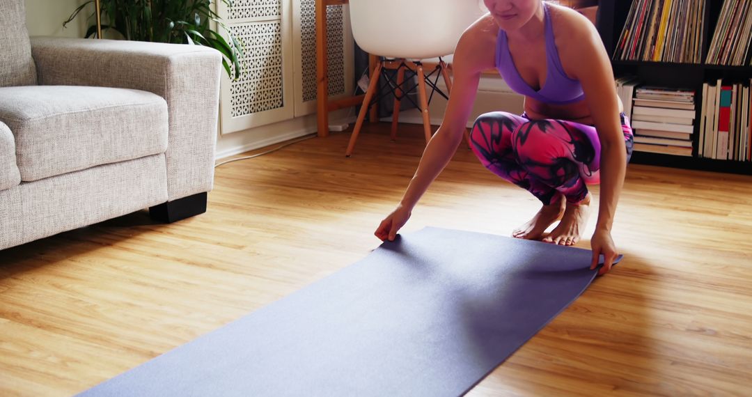 Woman Preparing Yoga Mat in Bright Living Room - Free Images, Stock Photos and Pictures on Pikwizard.com