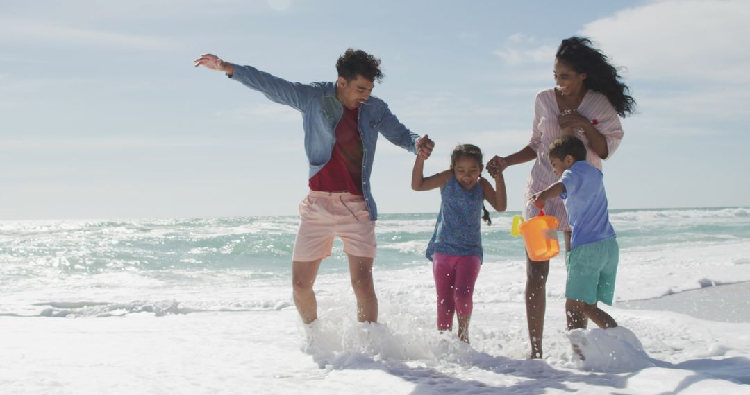 Joyful Family Playing Together on Sunny Beach Shore