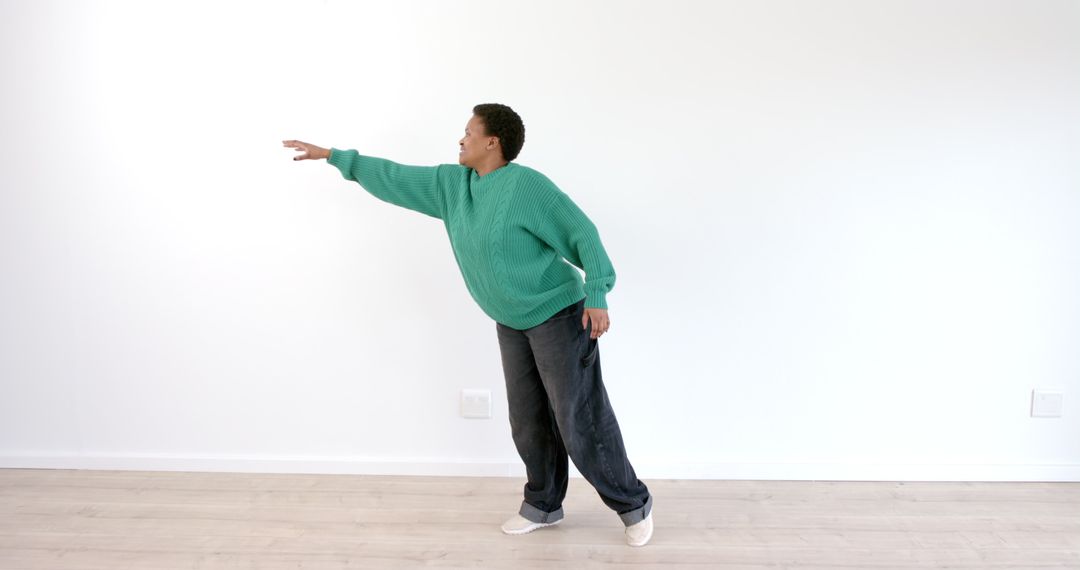 Man Mastering Balance with Graceful Pose in Minimal Space - Free Images, Stock Photos and Pictures on Pikwizard.com