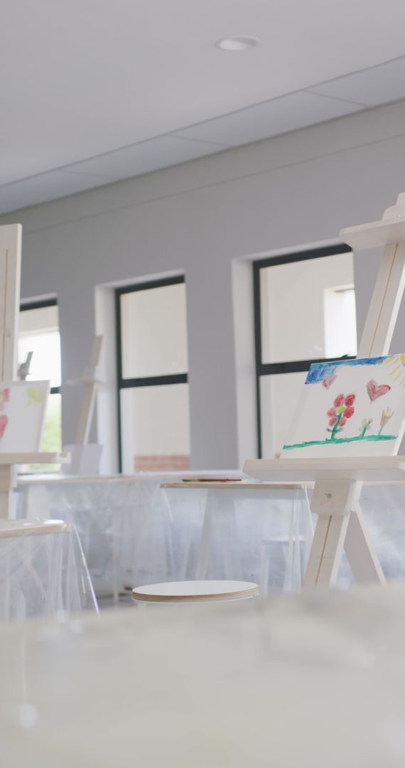 Empty Art Classroom with Paintings on Easels in Bright Natural Light - Free Images, Stock Photos and Pictures on Pikwizard.com