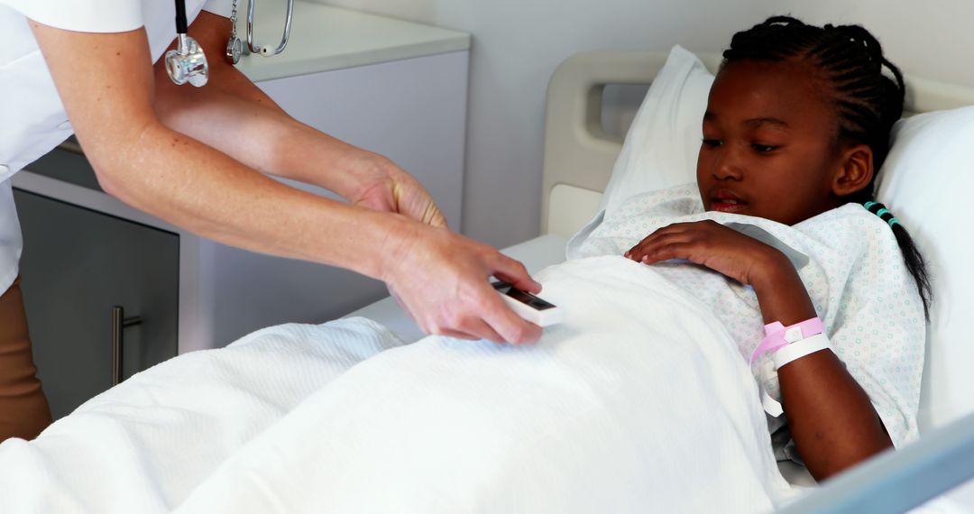 Doctor Examining Young Patient in Hospital Bed - Free Images, Stock Photos and Pictures on Pikwizard.com