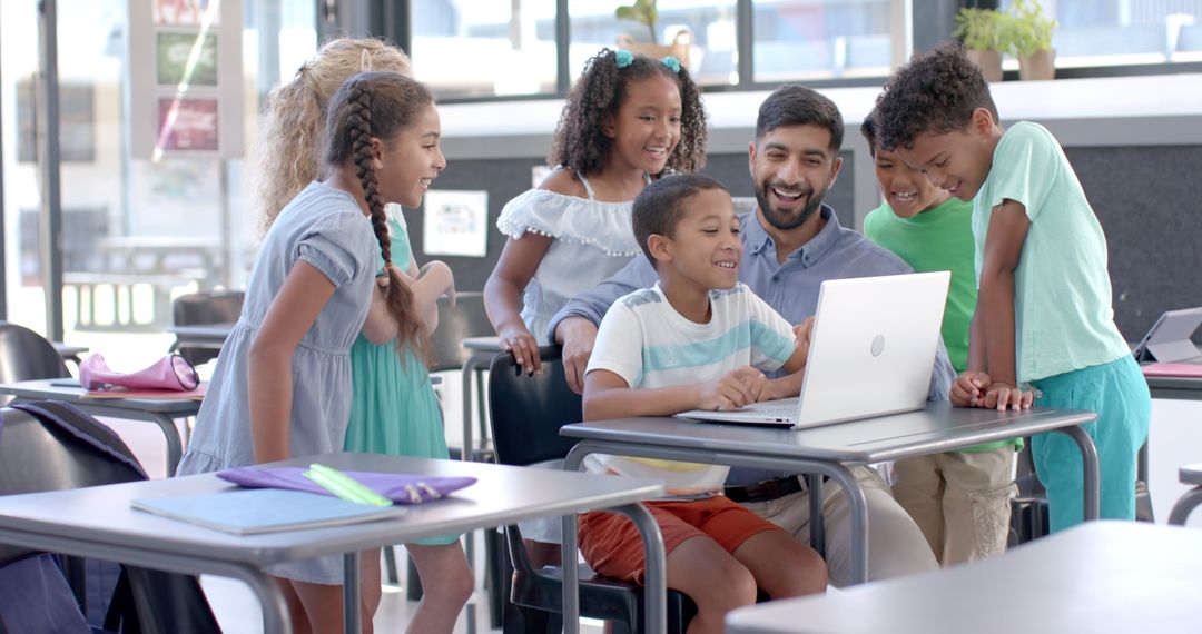 Enthusiastic Teacher and Diverse Students Engaged with Laptop in Classroom