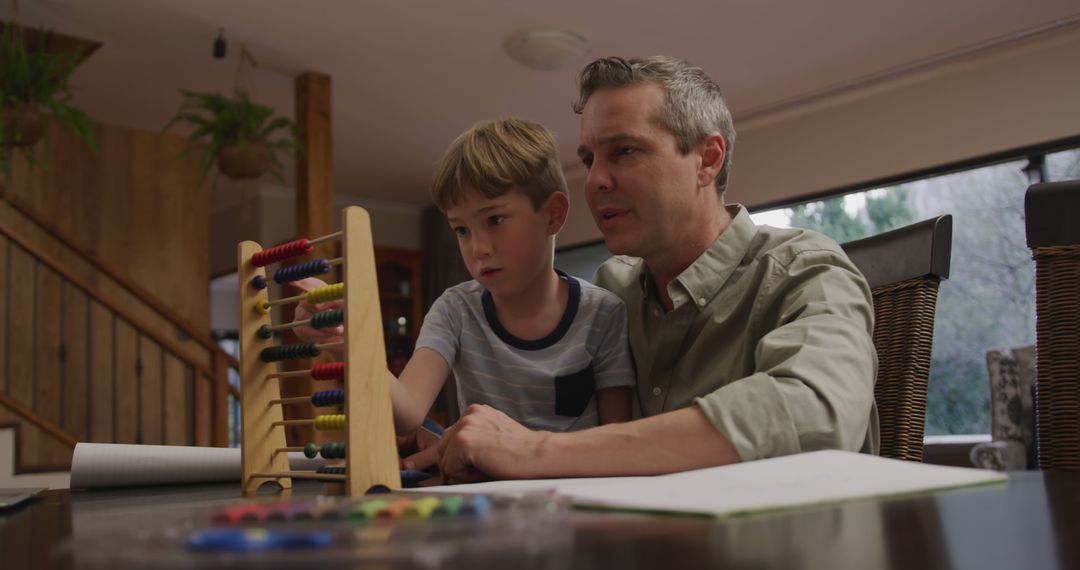 Father Teaching Son with Abacus During Homework - Free Images, Stock Photos and Pictures on Pikwizard.com