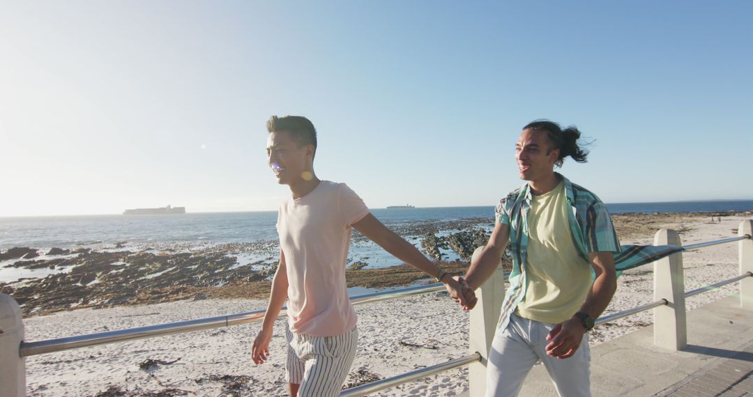 Romantic Couple Walking by Ocean on Sunny Day - Free Images, Stock Photos and Pictures on Pikwizard.com