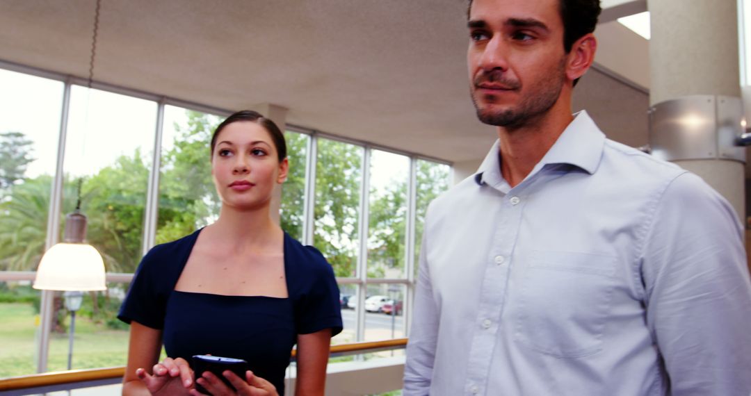 Young Professionals Discussing Work Colleagues in Office