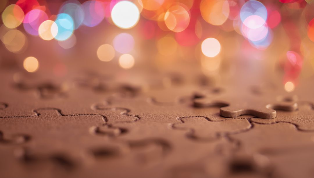 Puzzle Piece Rising with Festive Colored Bokeh in Background