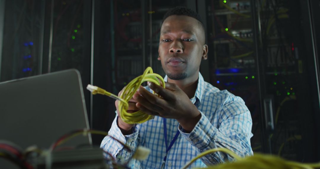 IT Engineer Managing Cables in Data Center