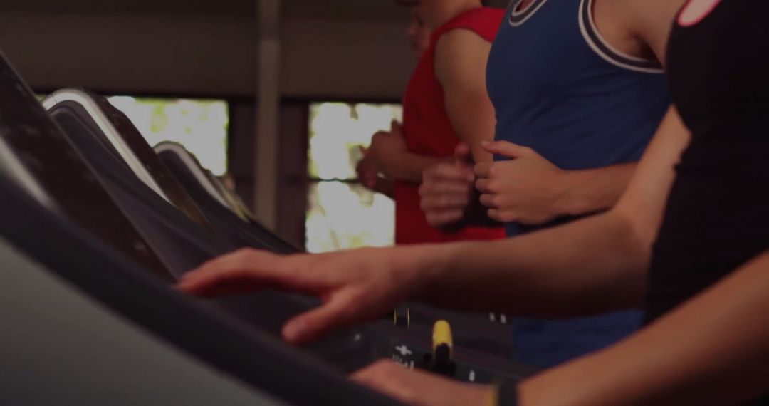 Active Adults Running on Treadmills in Gym Setting