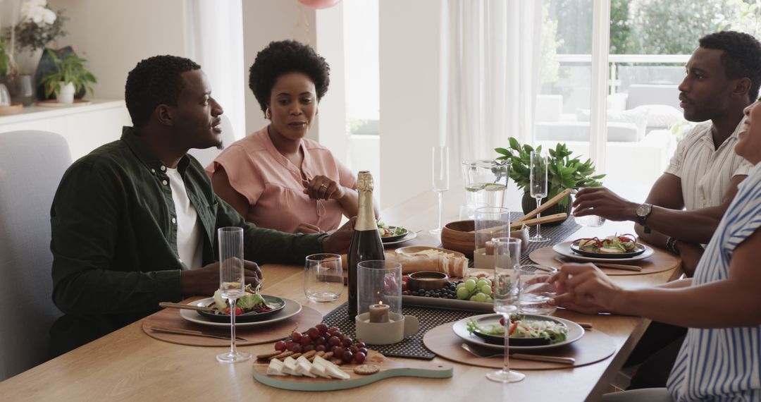 Friends Enjoying Lively Discussion Over Lunch at Home