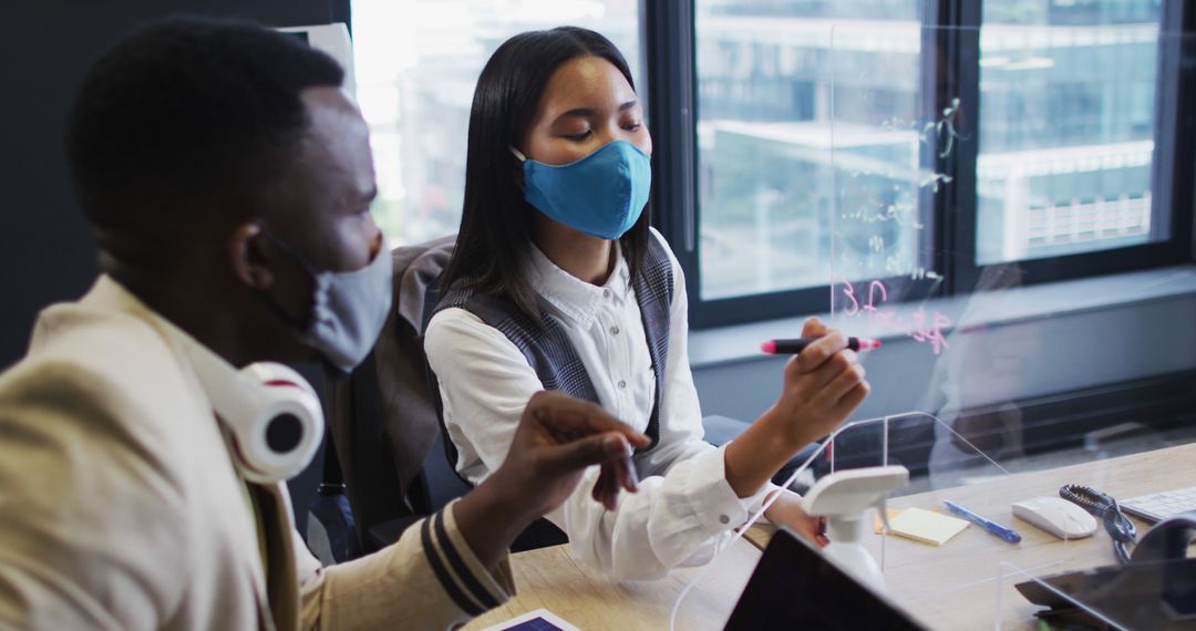 Diverse Team Collaborating with Safety Measures in Office Setting