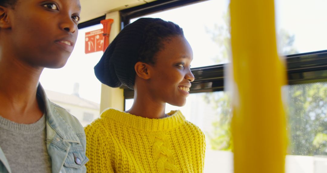 African American Twins Smiling While Traveling by Bus