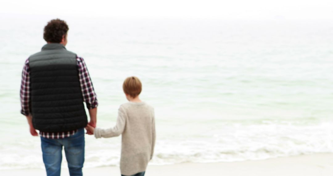 Father and Son Walking on Beach, Holding Hands - Free Images, Stock Photos and Pictures on Pikwizard.com