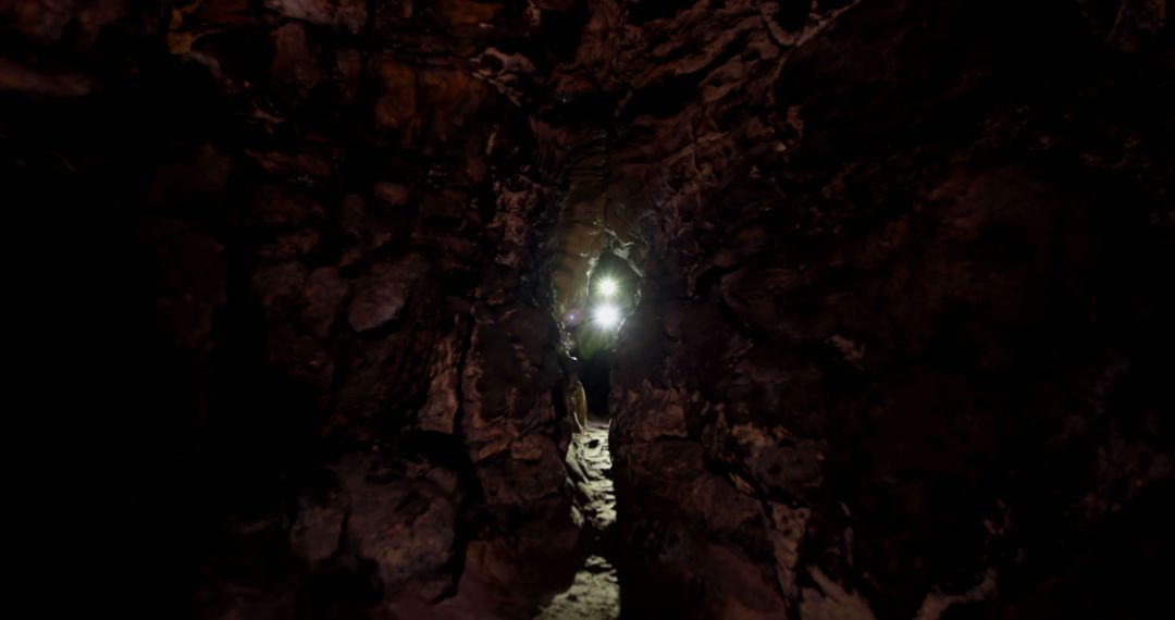 Explorers with Headlamps in Dark Narrow Cave Passage - Free Images, Stock Photos and Pictures on Pikwizard.com