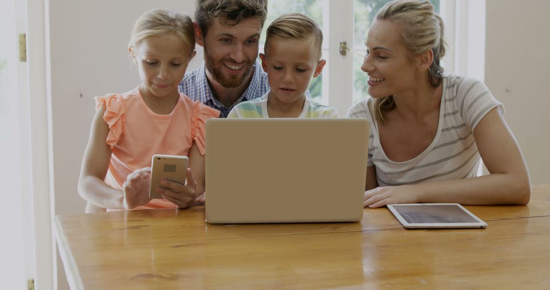 Happy family using technology devices at home - Free Images, Stock Photos and Pictures on Pikwizard.com