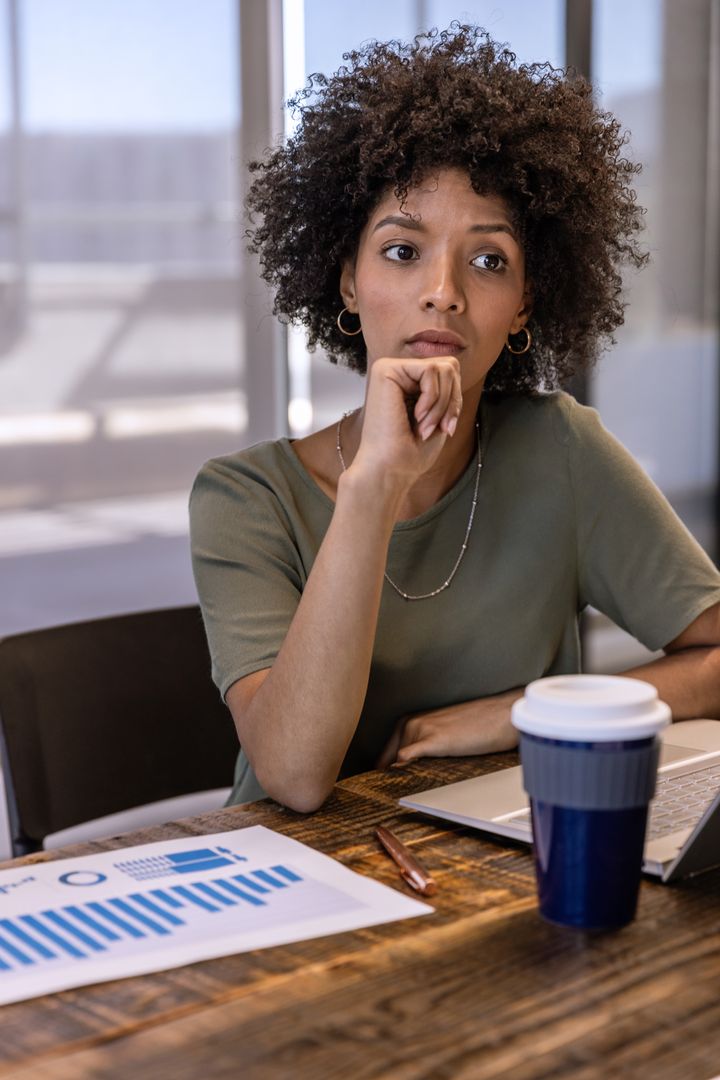 Contemplative Professional Analyzing Data in Modern Office