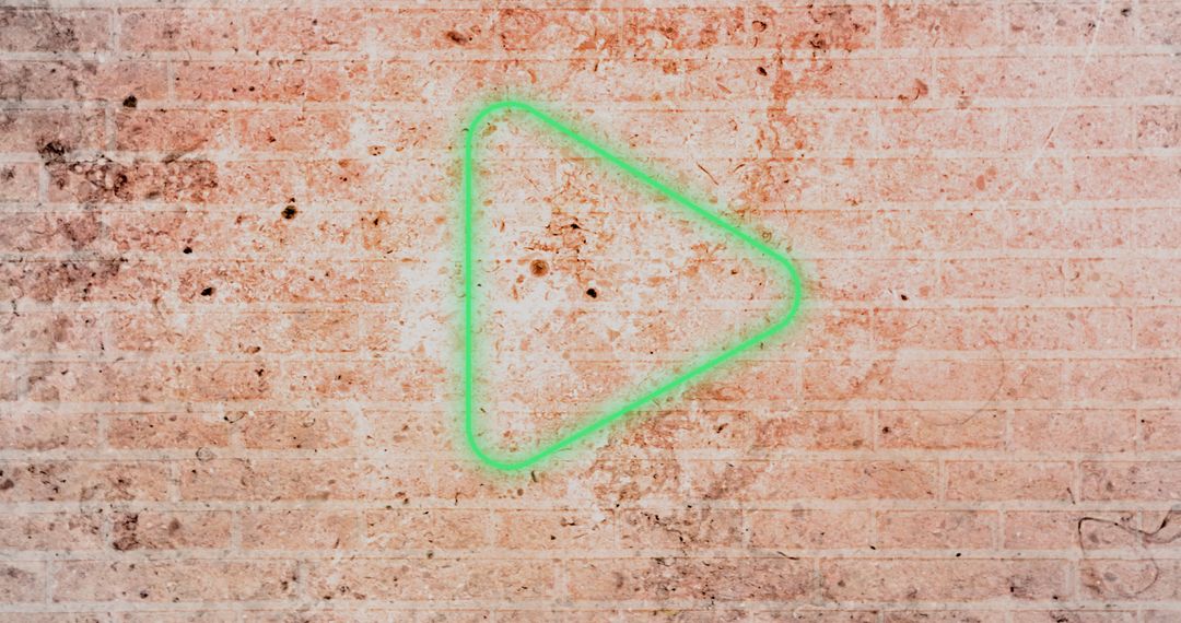 Green Neon Play Button on Rustic Brick Background