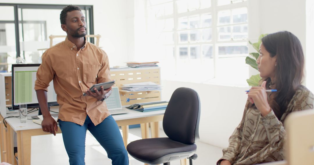 Diverse Workplace Discussion Between Colleagues for Effective Teamwork