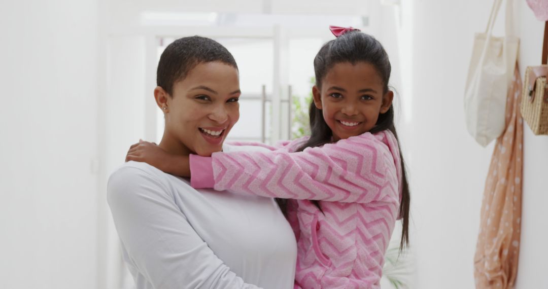 Smiling Mother Holding Daughter in Cozy Home Environment - Free Images, Stock Photos and Pictures on Pikwizard.com