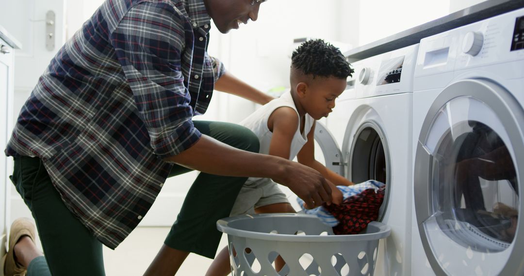 Father and Son Doing Laundry Together at Home - Free Images, Stock Photos and Pictures on Pikwizard.com