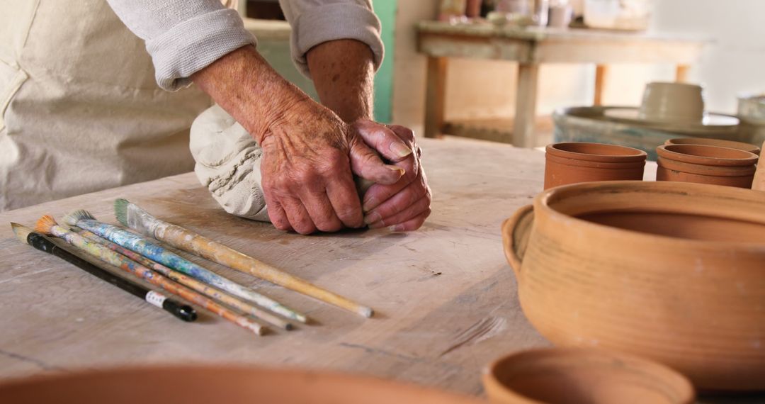 Senior Artisan Sculpting Clay in Pottery Studio with Ceramic Tools and Bowls - Free Images, Stock Photos and Pictures on Pikwizard.com