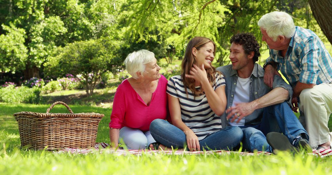 Smiling Multigenerational Family Enjoying Outdoor Picnic in Park - Free Images, Stock Photos and Pictures on Pikwizard.com