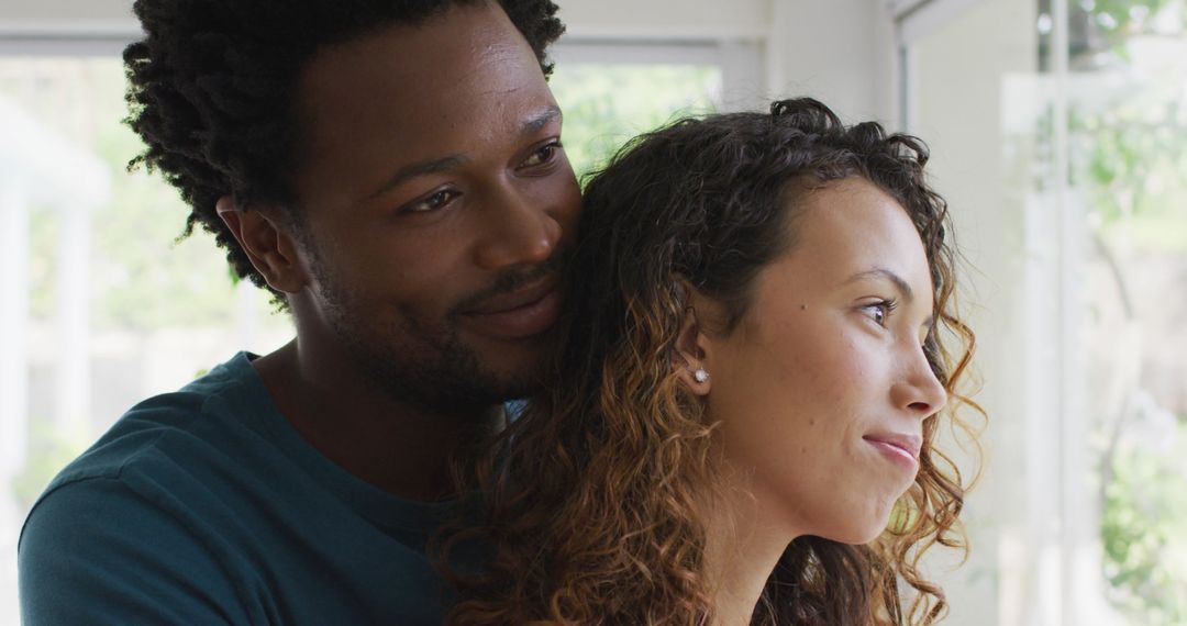 Affectionate Couple Embracing by Sunlit Window