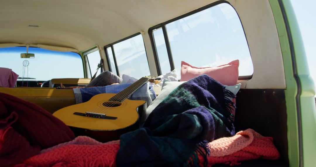 Cozy Camper Van Interior with Acoustic Guitar and Blankets - Free Images, Stock Photos and Pictures on Pikwizard.com