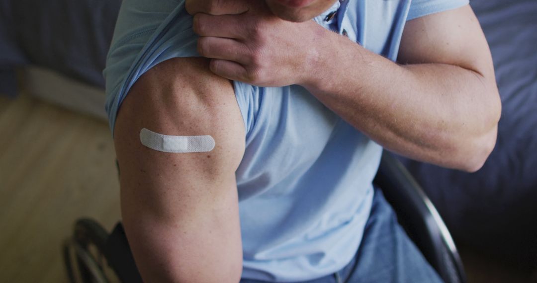 Person in wheelchair with vaccination bandage on upper arm - Free Images, Stock Photos and Pictures on Pikwizard.com