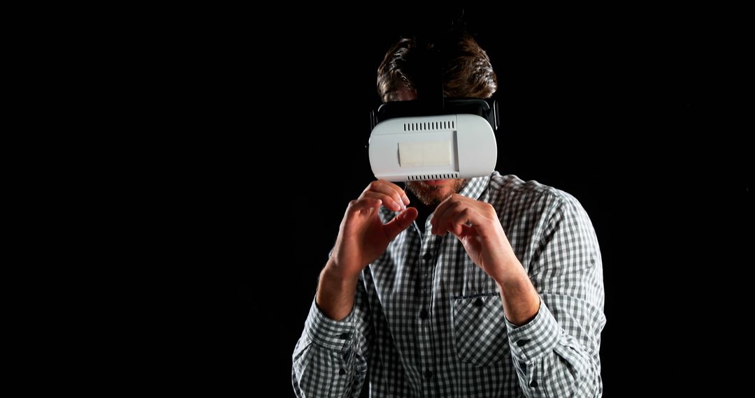 Man Experiencing Virtual Reality with VR Headset in Dark Background - Free Images, Stock Photos and Pictures on Pikwizard.com