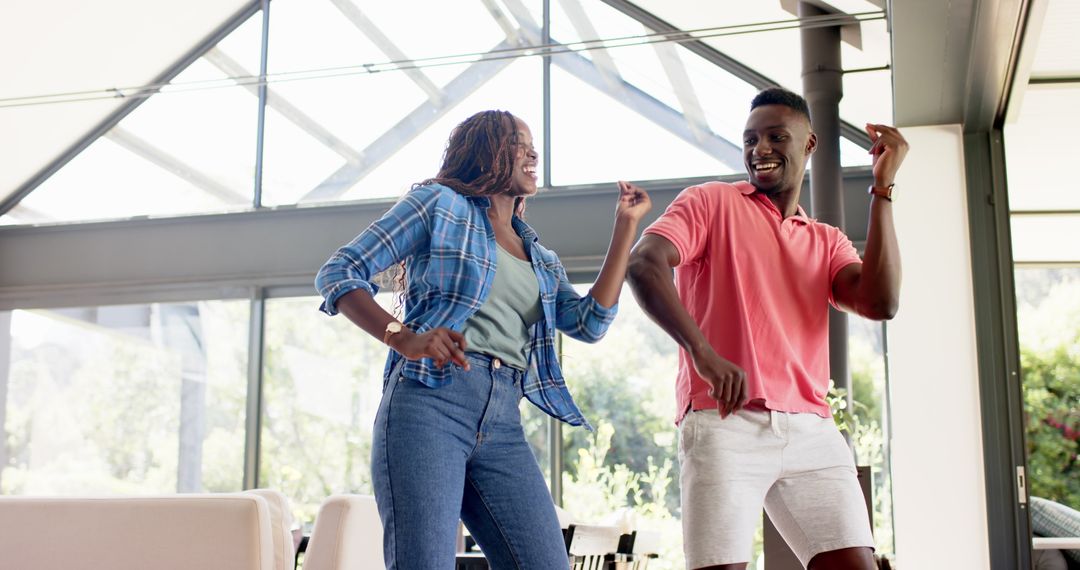 Joyful Couple Dancing Together at Home in Living Room