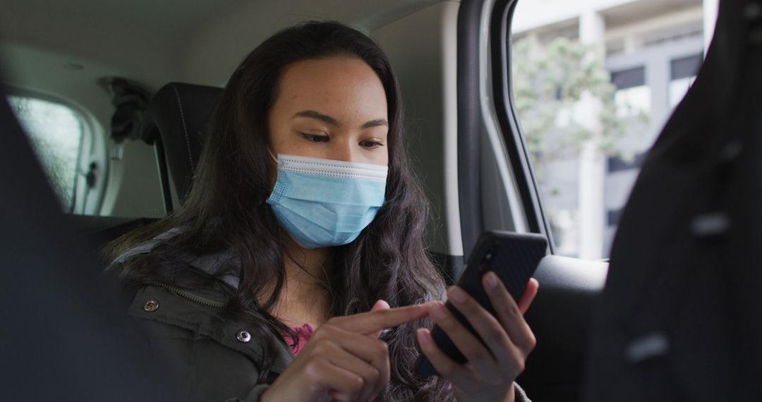 Young Woman with Face Mask Using Smartphone in Car - Free Images, Stock Photos and Pictures on Pikwizard.com