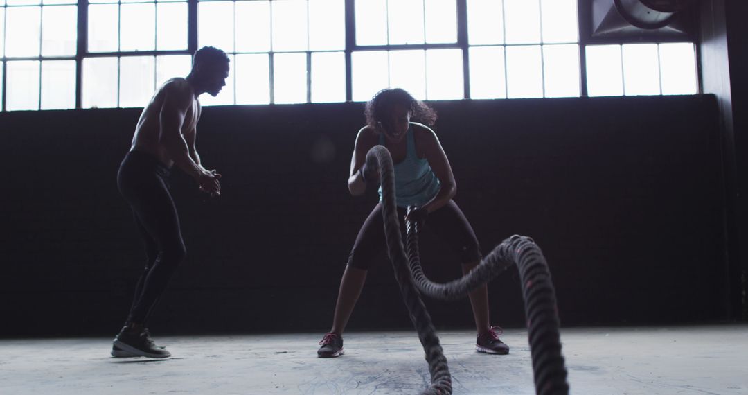 Fitness Enthusiasts Performing Battle Ropes Workout in Gym - Free Images, Stock Photos and Pictures on Pikwizard.com