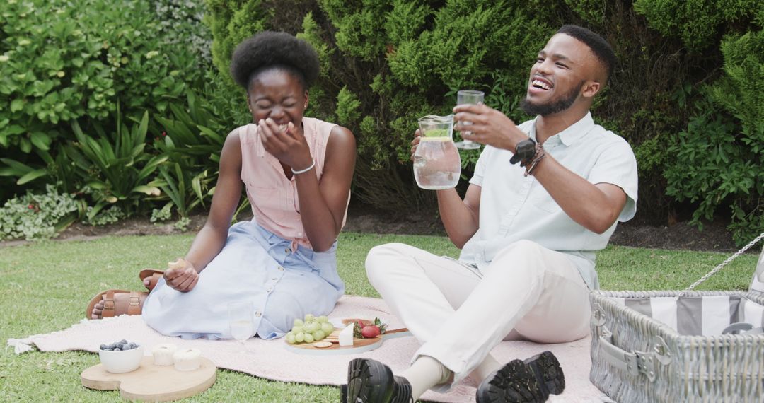 Joyful Picnic with Couple Sharing Drinks and Snacks Outdoors