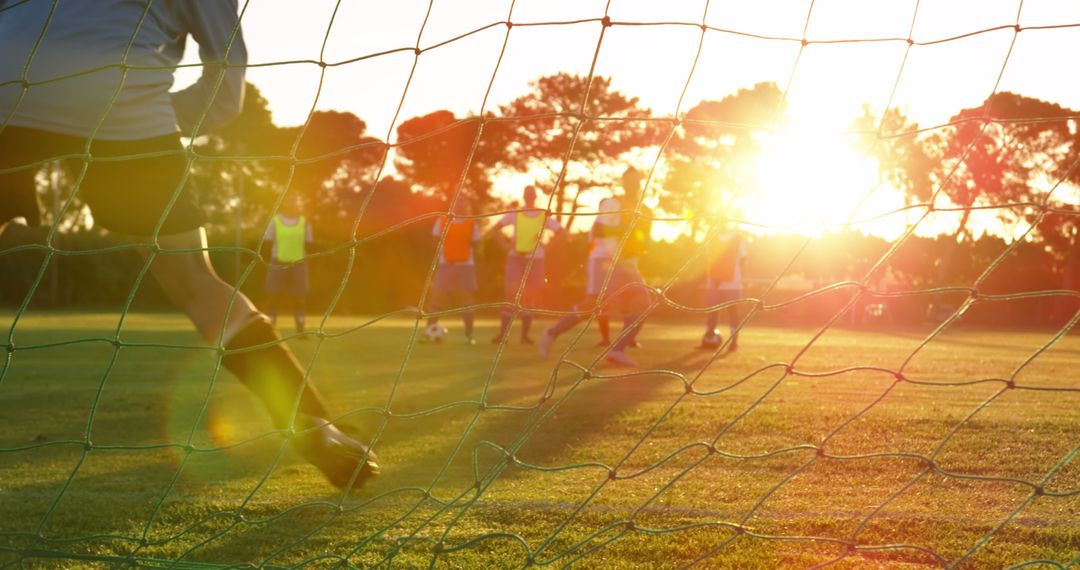 Youth Soccer Players Practicing on Field at Sunset - Free Images, Stock Photos and Pictures on Pikwizard.com