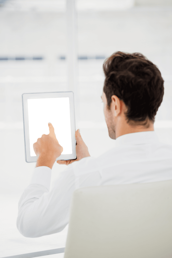 Businessman Pointing at Transparent Tablet in Office Environment