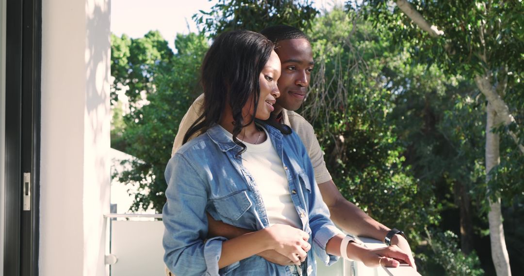 Romantic Couple Enjoying Tranquil Moment on Sunlit Balcony