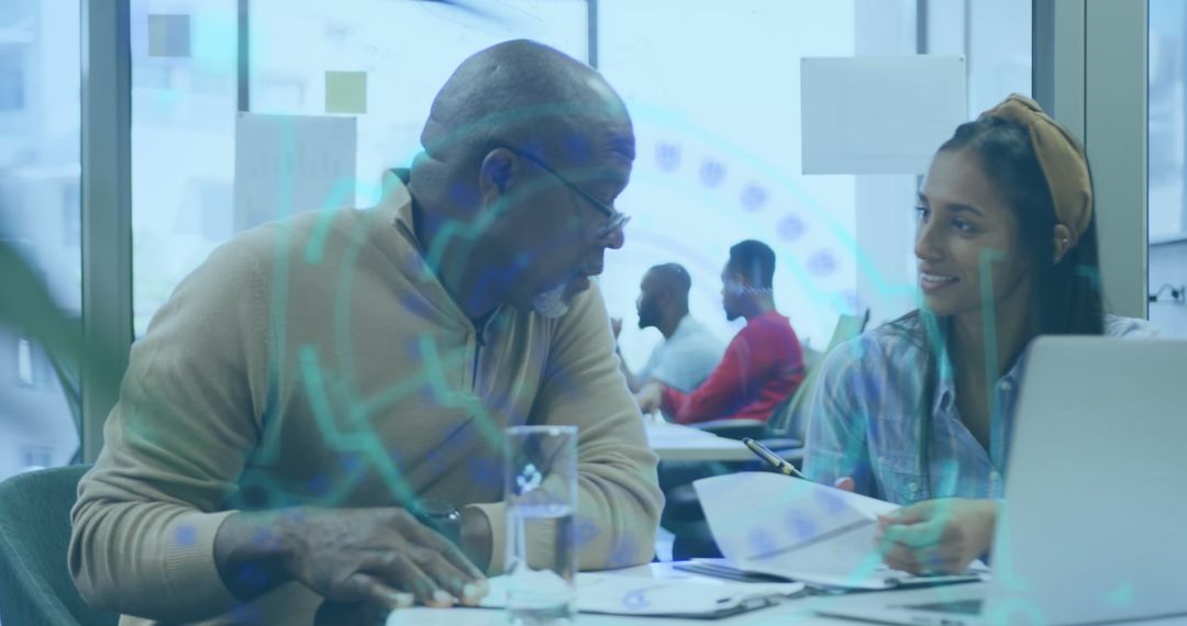 Colleagues Discussing Financial Data in Modern Office