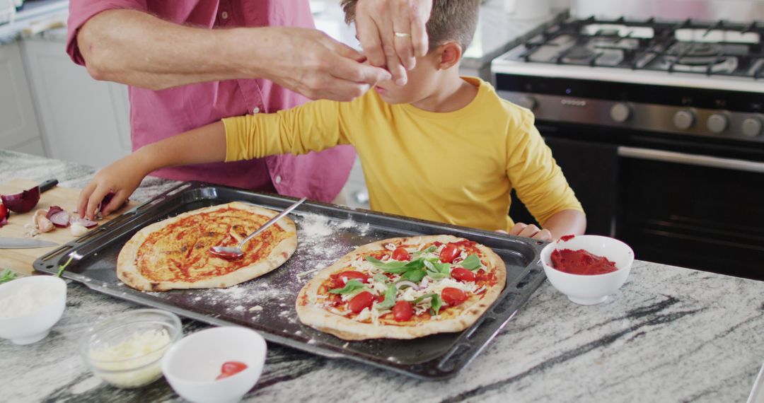 Child and Adult Making Homemade Pizzas Together in Kitchen - Free Images, Stock Photos and Pictures on Pikwizard.com