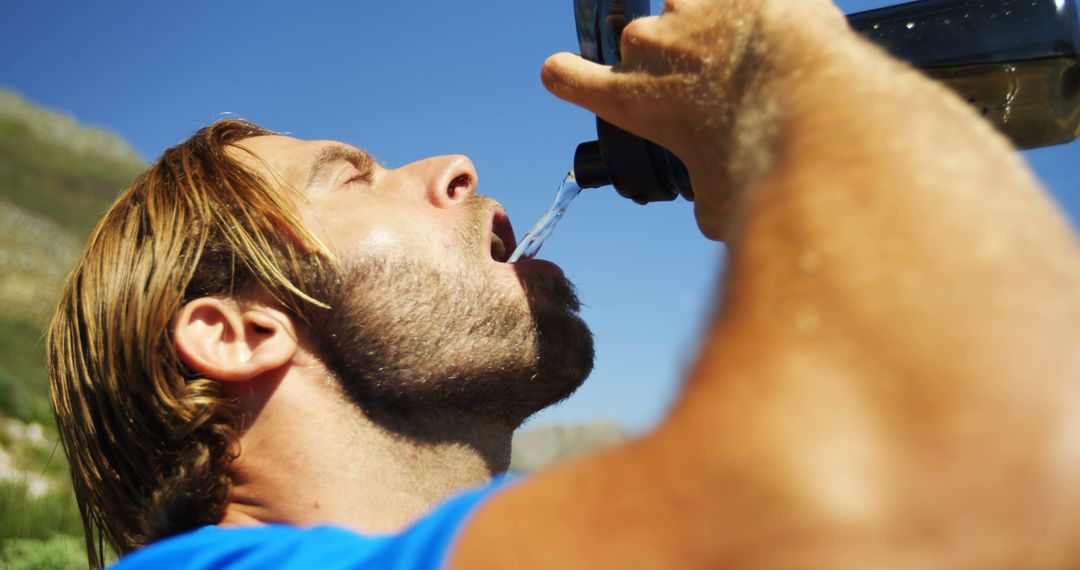 Athletic Man Hydrating Outdoors with Water Bottle - Free Images, Stock Photos and Pictures on Pikwizard.com