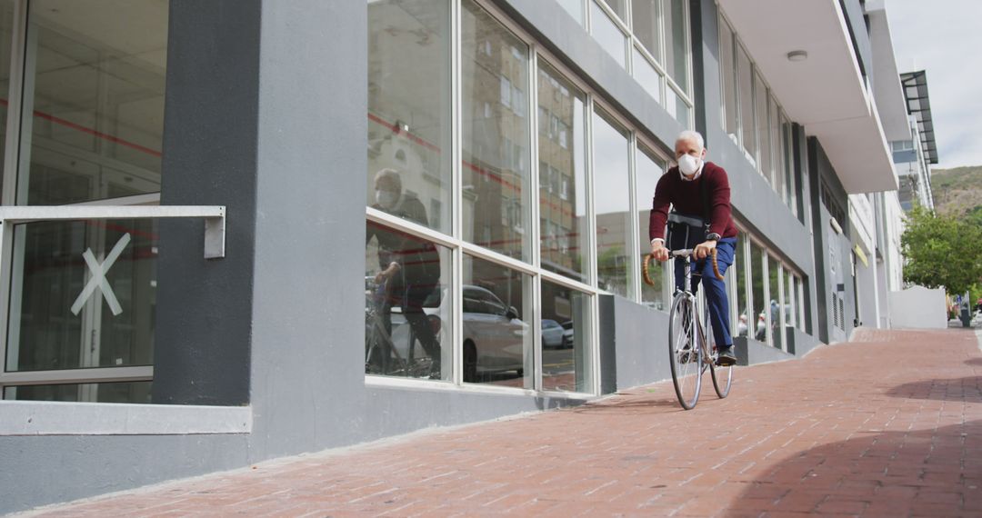 Senior Man Riding Bicycle on Urban Street - Free Images, Stock Photos and Pictures on Pikwizard.com