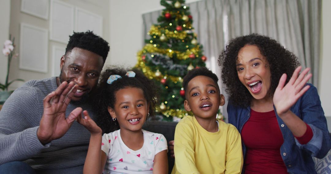 A joyful African American family celebrates Christmas together during a video call at home. - Free Images, Stock Photos and Pictures on Pikwizard.com