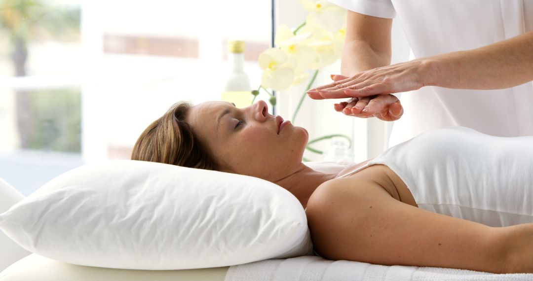 Woman Receiving Reiki Healing Session in Wellness Center - Free Images, Stock Photos and Pictures on Pikwizard.com