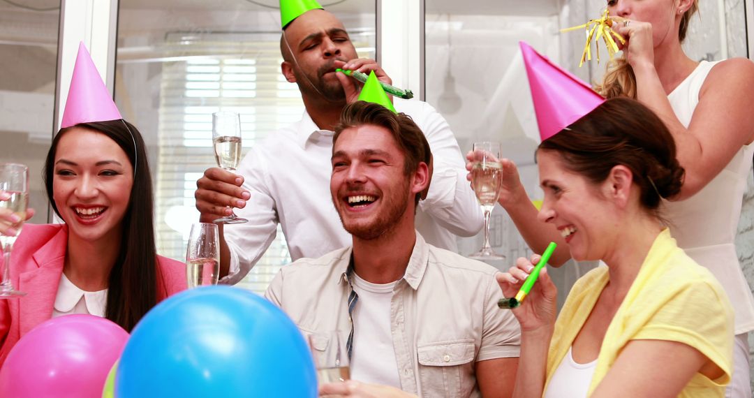 Diverse Team Celebrating with Party Hats and Champagne in Office - Free Images, Stock Photos and Pictures on Pikwizard.com