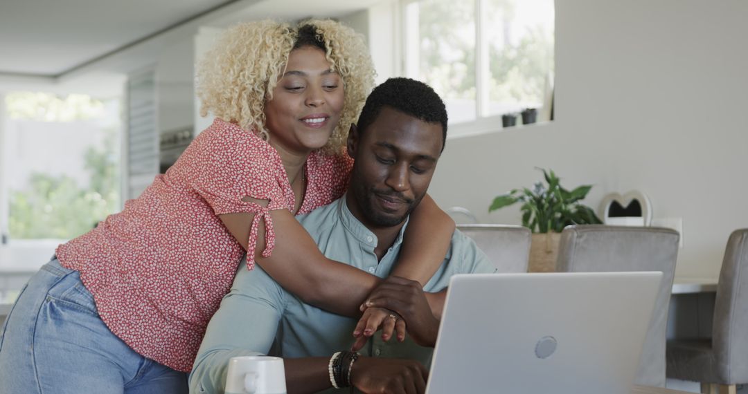 Happy Couple Using a Laptop Together at Home