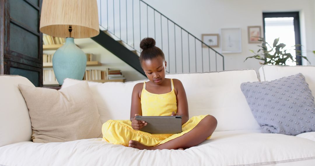 Young Girl Enjoying Digital Tablet in Comfortable Home Environment