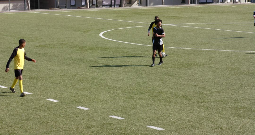 Young Soccer Players Practicing Teamwork on Sunny Field